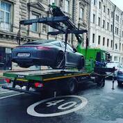 Tow truck craning porche onto bed